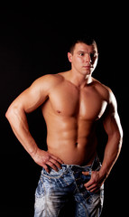 Obraz na płótnie Canvas handsome muscular guy posing
