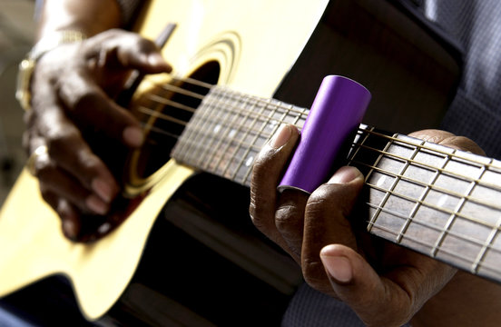 African American man playing guitar