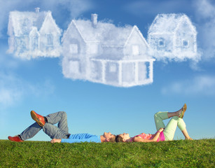 lying couple on grass and dream three cloud houses collage - obrazy, fototapety, plakaty