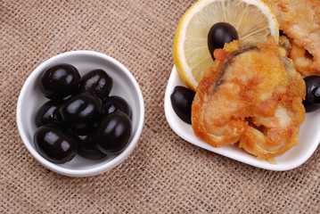 Fried fish with a lemon and olives