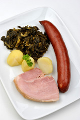 smoked sausage and organic curly on a plate