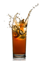 Beautiful splash of cola in glass isolated on white