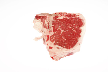A raw T-bone steak isolated on white