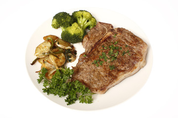 T-Bone steak dinner with sides of potatoes and broccoli