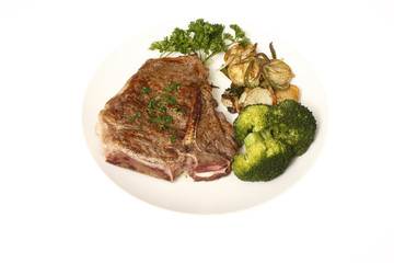 T-Bone steak dinner with sides of potatoes and broccoli