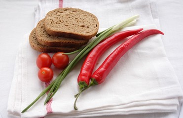 Rye bread with tomatoes cherry on the white towel