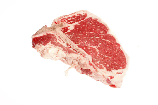 A raw T-bone steak isolated on white