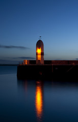 Old Lighthouse with morning sky and calm sea