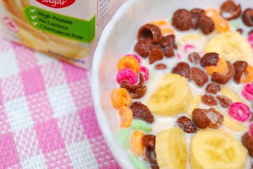 Healthy cereal topped with fruit and raisins