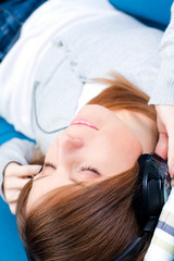 Young girl listening to music. Eyes closed