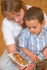 Mum and the son look the book