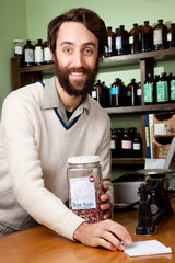 Smiling proprietor checks his list