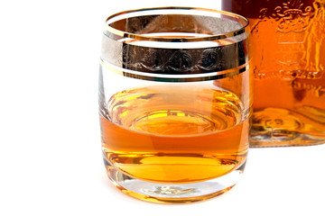 glass of whiskey with a bottle
