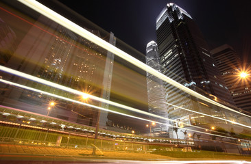 Fototapeta na wymiar Skyscraper with traffic lighst and cars motion in Hong Kong