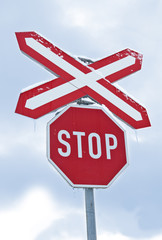 Traffic sign of "Stop" in front of the railway. Small icicles