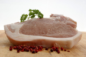 one raw organic pork chop and parsley