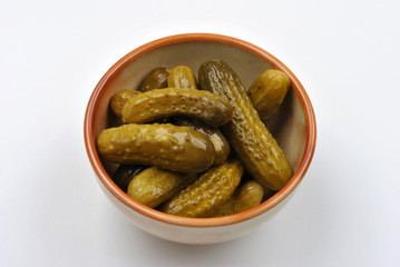 some organic sour gherkin and a white background