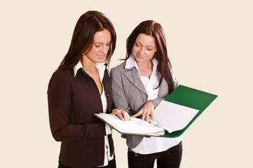 Two young women reading file (angled view)