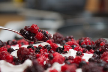 Decorating cream cake with berries