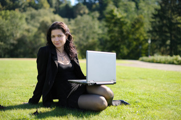 Young lady with a notebook in a park