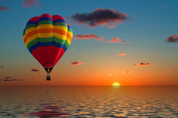 balloon flying into sunset