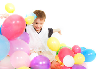 Fototapeta na wymiar young boy playing with balloons over white