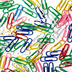 Multicoloured paperclips on the white background