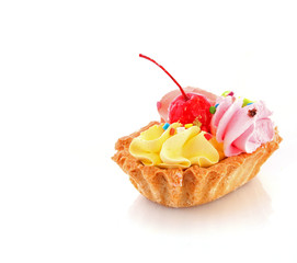 Pink cheesecake with maraschino cherry  on white