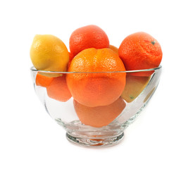 Oranges tangerines and lemon in glass vase isolated