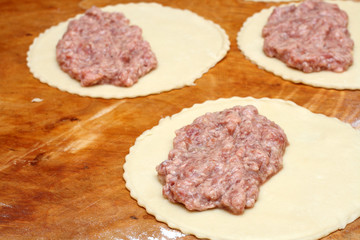 half-finished patty on wooden board