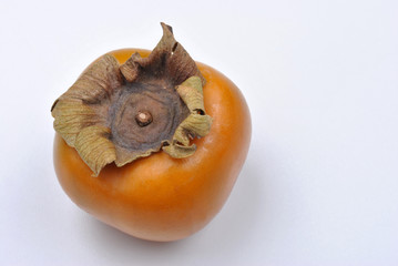 one organic sharon fruit and a white background