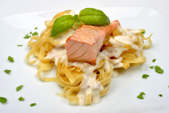 cooked  organic wild salmon steak and pasta on a plate