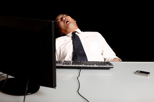 A Businessman Asleep At His Desk.