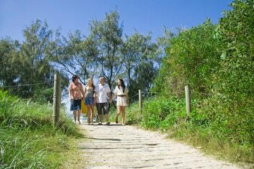 Fototapeta premium family walking from the beach talking and giggeling
