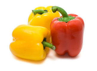 two yellow and red bell peppers isolated on a white background