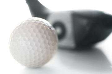 closeup of a golf ball and club