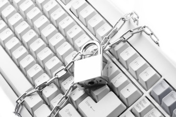 Computer  keyboard secured with chain and padlock..