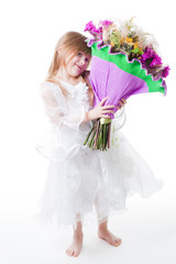 Little girl in white dress hold bouquet of flowers