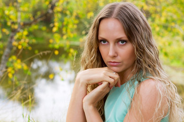 Beautiful sad woman relaxing on nature.