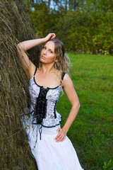 Beautiful young woman and haystack.