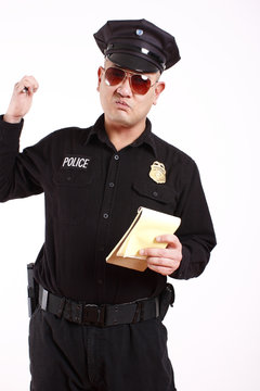 A Male Police Officer Writing A Citation.