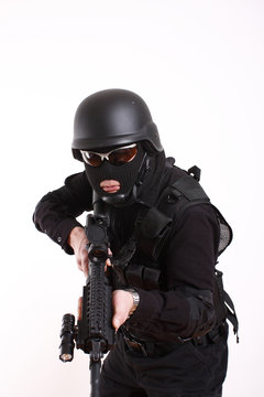 SWAT police officer with assault gun.