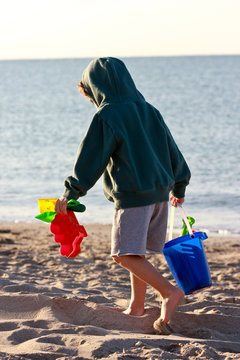 child with colorful buckets