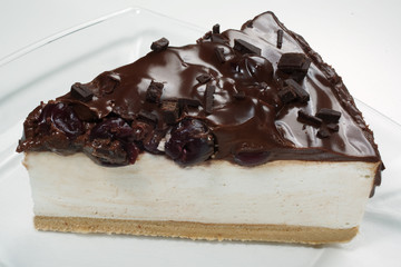 slice of sheesecake with chocolate and cherries