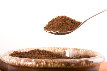 Coffee grounds on a spoon.