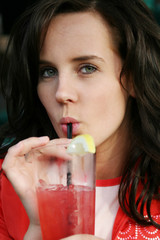 Beautiful woman sipping on a drink.