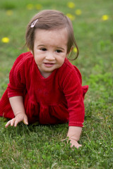 Baby girl on a spring meadow
