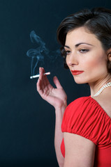 Obraz premium Beautiful Model in red smoking