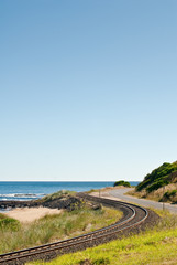 Coastal rail line by beach and ocean