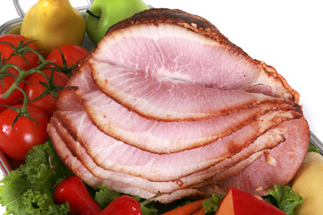 Close up of a baked ham with trimmings